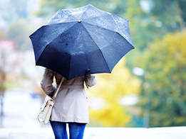 woman-on-phone-while-holding-an-umbrella